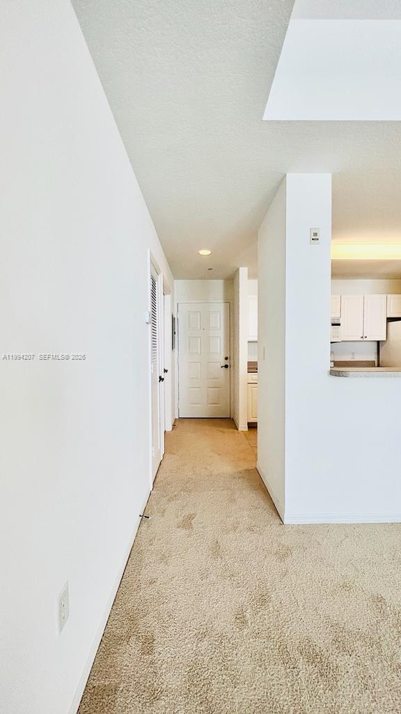 1209 Main Street, Unit 315 Jupiter, FL 33458 - Photo 7 of 18 a view of a hallway with wooden shelves