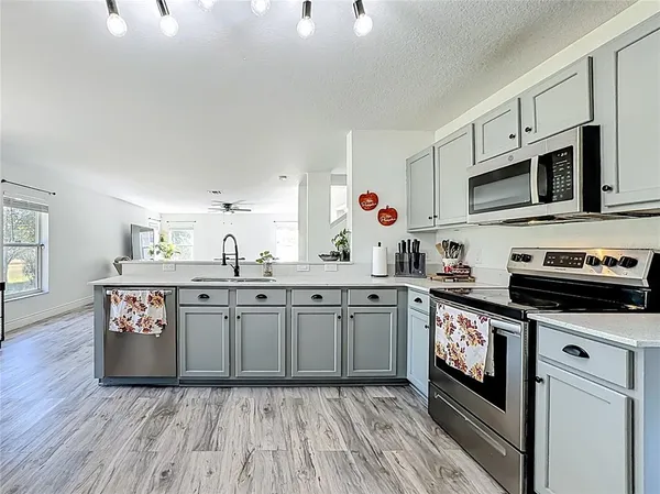 a kitchen with stainless steel appliances a refrigerator and cabinets