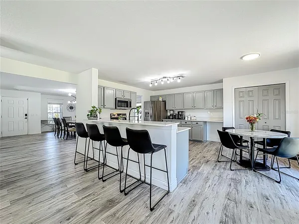 a living room with furniture a ceiling fan and a rug