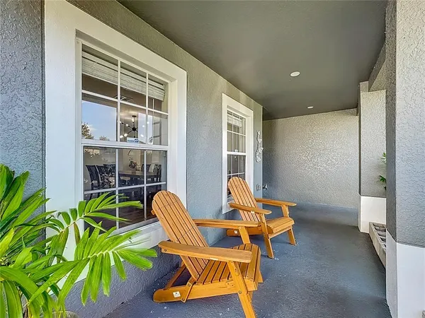 a living room with furniture and floor to ceiling window