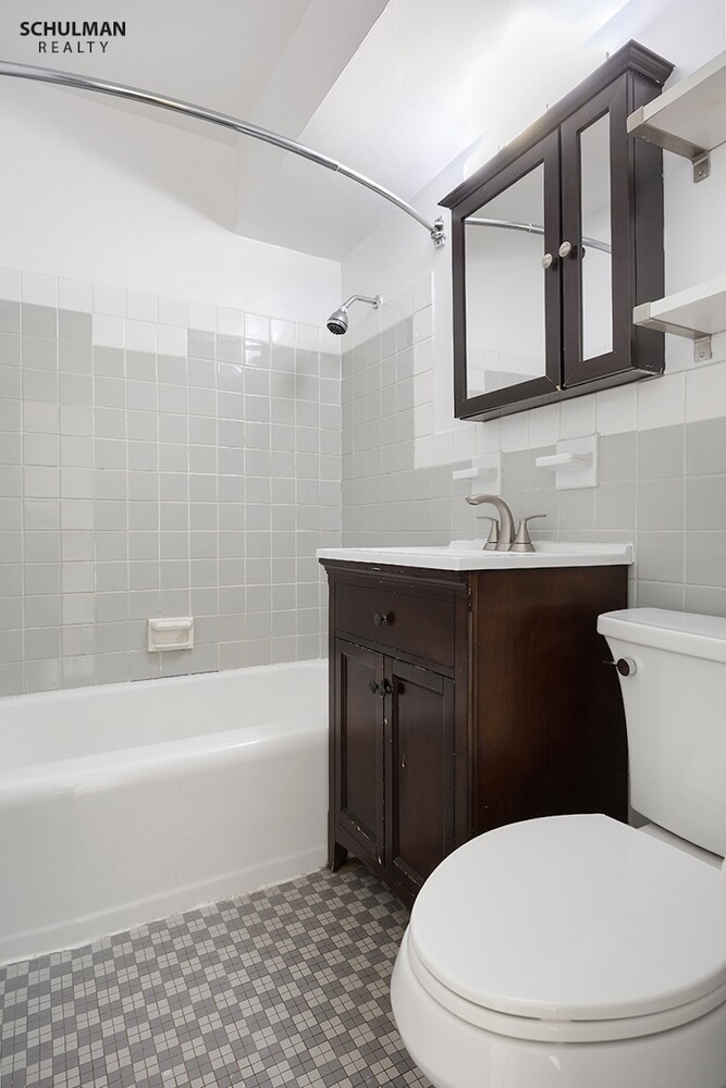 411 East 53rd Street, Unit 14F Manhattan, NY 10022 - Photo 11 of 20 a bathroom with a sink a toilet and bathtub