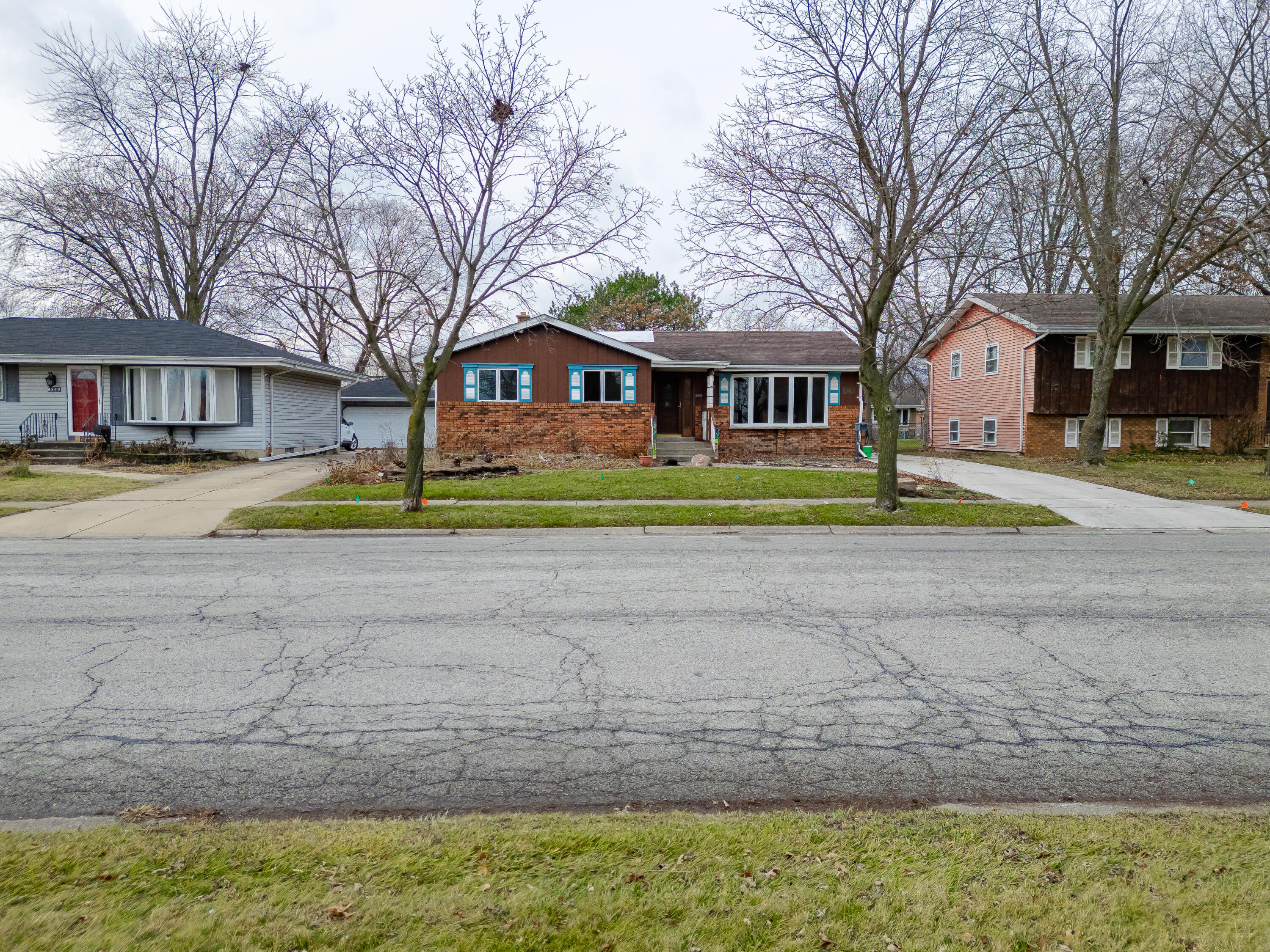 8534 Harrison Avenue Munster, IN 46321 - Photo 1 of 1 a yellow house with trees in front of it