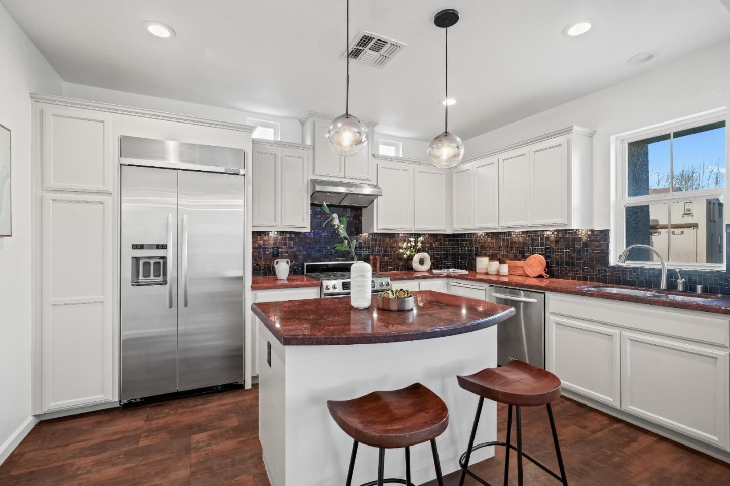 451 Chagall Street Mountain View, CA 94041 - Photo 12 of 58 a kitchen with stainless steel appliances granite countertop a refrigerator a sink dishwasher a dining table and chairs with wooden floor