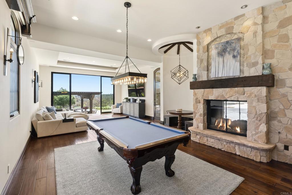 5293 La Glorieta Rancho Santa Fe, CA 92067 - Photo 11 of 25 a living room with furniture a table and a fireplace