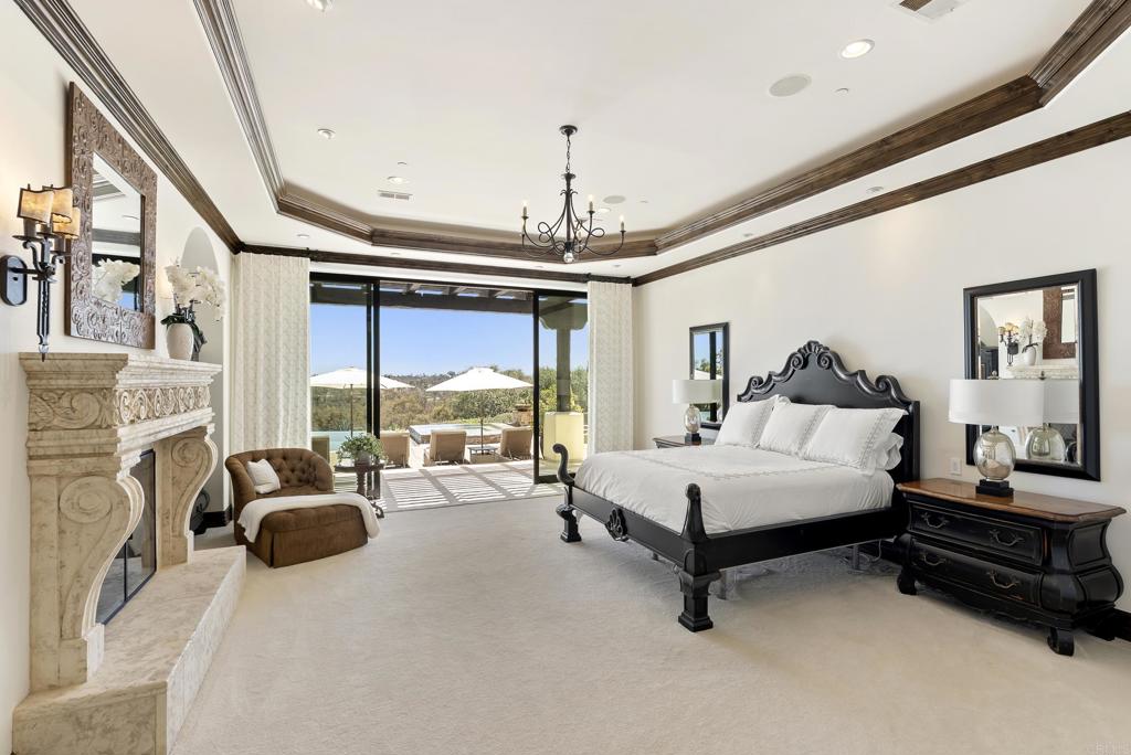 5293 La Glorieta Rancho Santa Fe, CA 92067 - Photo 12 of 25 a spacious bedroom with a bed couch and a large window