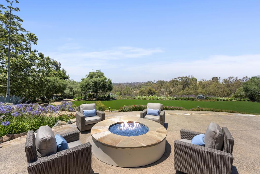 5293 La Glorieta Rancho Santa Fe, CA 92067 - Photo 17 of 25 a view of a patio with couches chairs and a fire pit