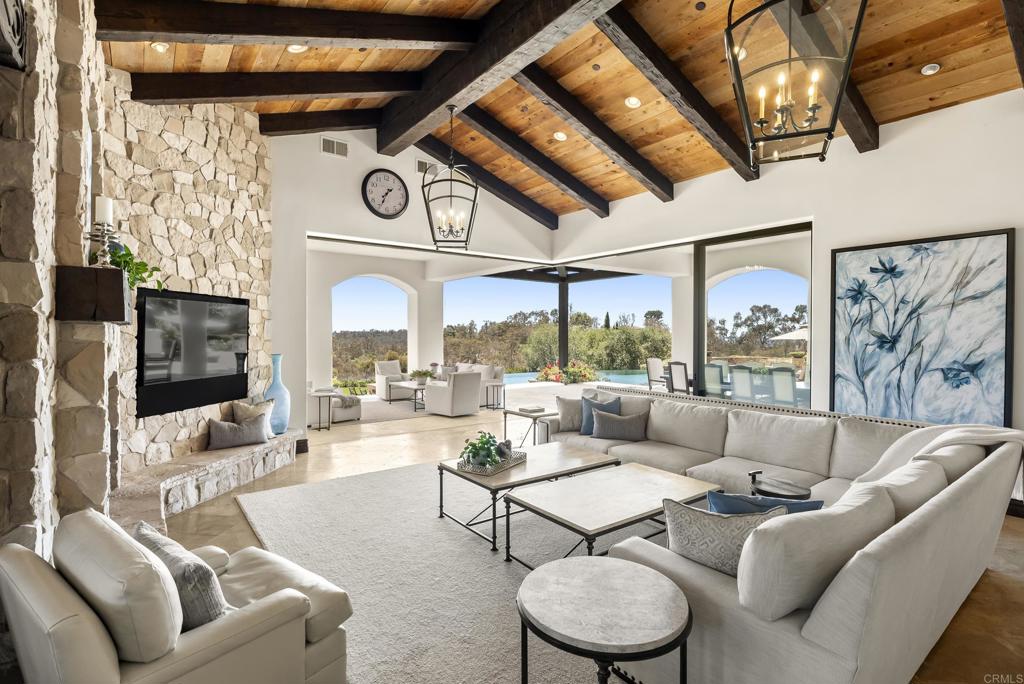 5293 La Glorieta Rancho Santa Fe, CA 92067 - Photo 2 of 25 a living room with furniture a clock and a large window