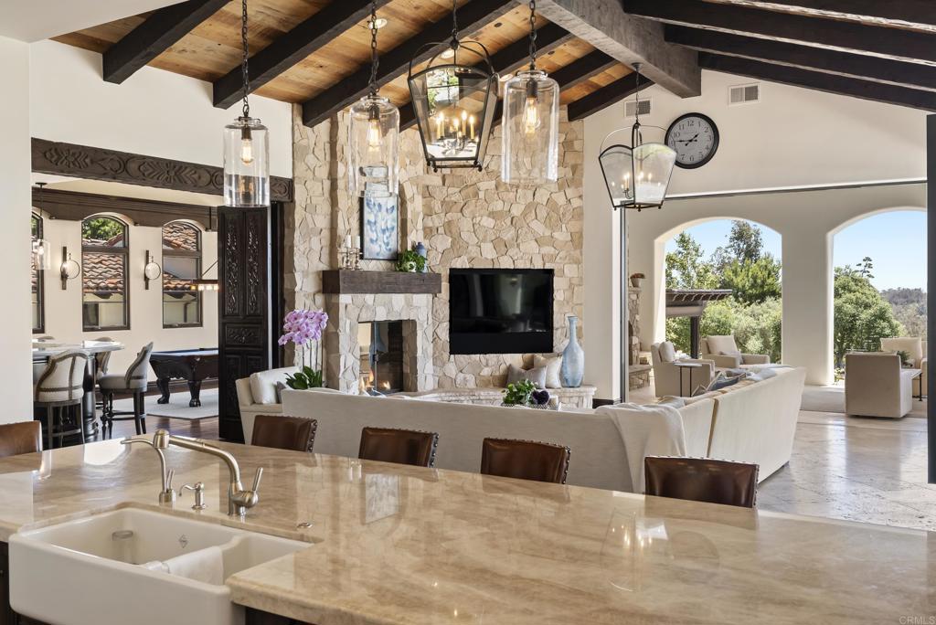 5293 La Glorieta Rancho Santa Fe, CA 92067 - Photo 7 of 25 a living room with furniture a fireplace and a flat screen tv
