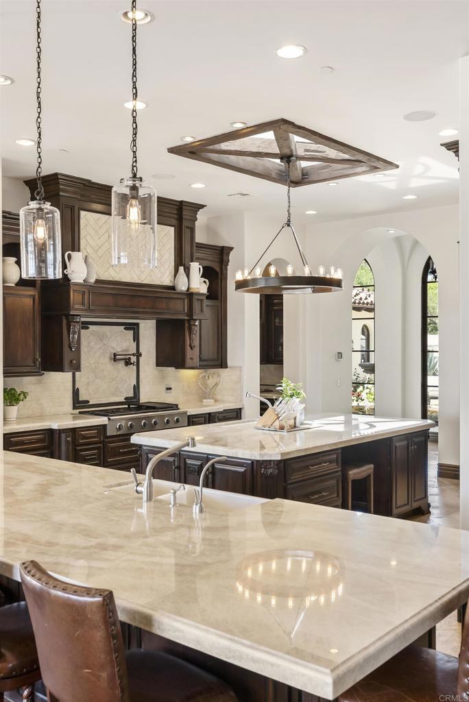 5293 La Glorieta Rancho Santa Fe, CA 92067 - Photo 8 of 25 a view of a kitchen with kitchen island stainless steel appliances a sink and living room view