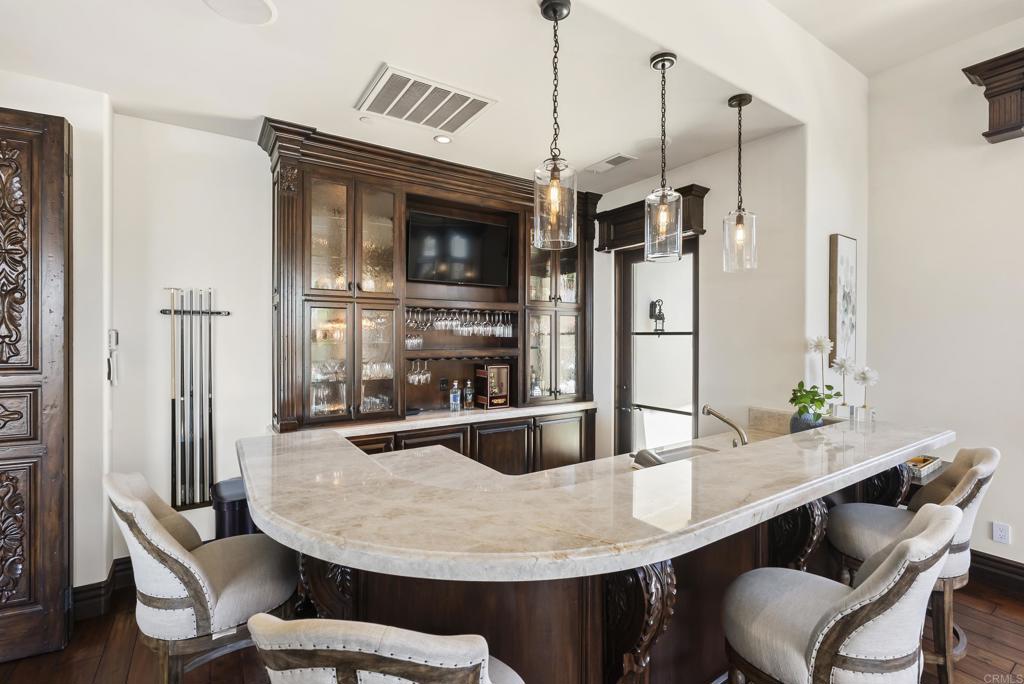 5293 La Glorieta Rancho Santa Fe, CA 92067 - Photo 9 of 25 a kitchen with a table and chairs
