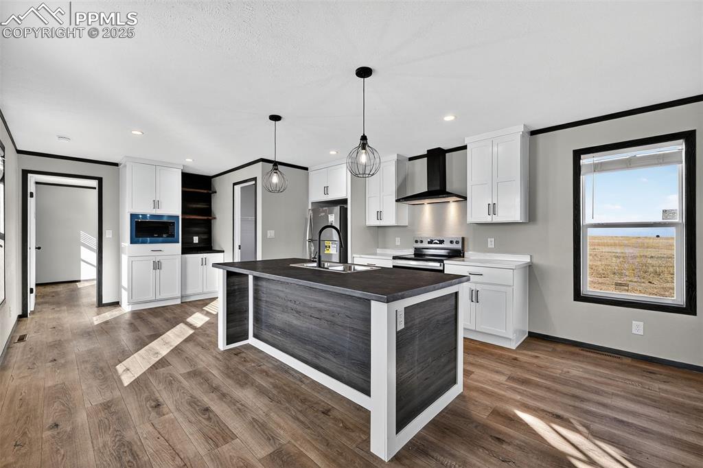 6815 Ramah Highway Yoder, CO 80864 - Photo 12 of 39 a kitchen with stainless steel appliances granite countertop a sink stove and refrigerator