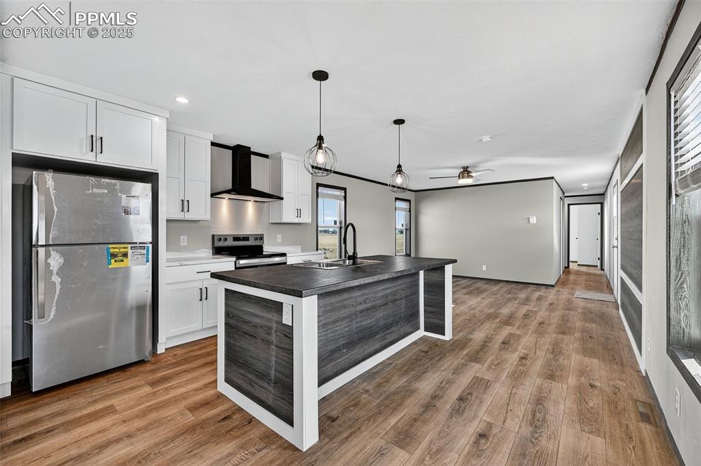 6815 Ramah Highway Yoder, CO 80864 - Photo 13 of 39 a kitchen with stainless steel appliances granite countertop a refrigerator a sink and a stove