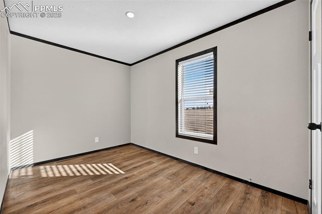 6815 Ramah Highway Yoder, CO 80864 - Photo 23 of 39 a view of an empty room with wooden floor and a window