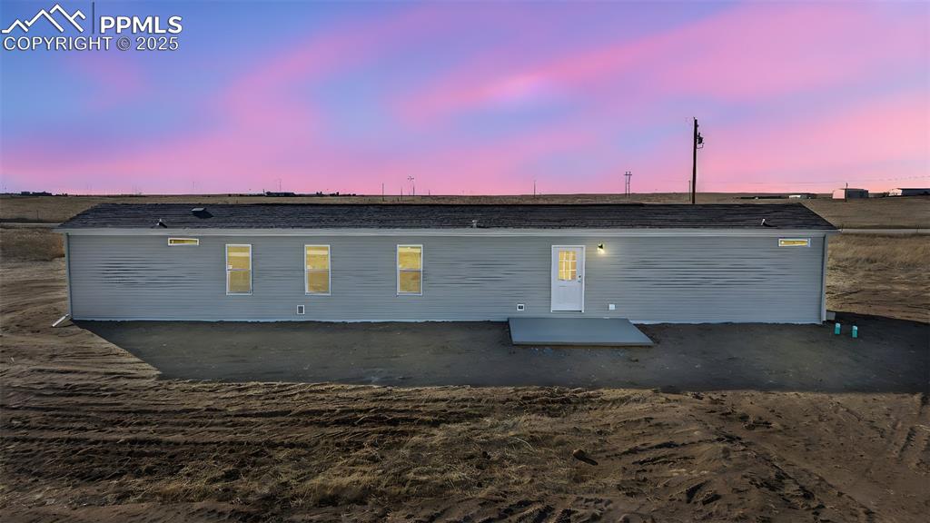 6815 Ramah Highway Yoder, CO 80864 - Photo 26 of 39 a front view of a house with a yard