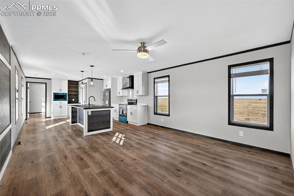 6815 Ramah Highway Yoder, CO 80864 - Photo 8 of 39 a view of a kitchen with wooden floor electronic appliances and cabinets
