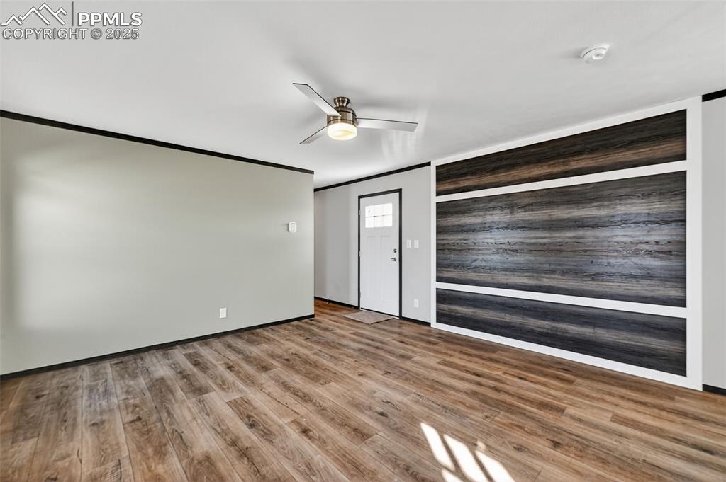 6815 Ramah Highway Yoder, CO 80864 - Photo 10 of 39 a view of an empty room with wooden floor and a window