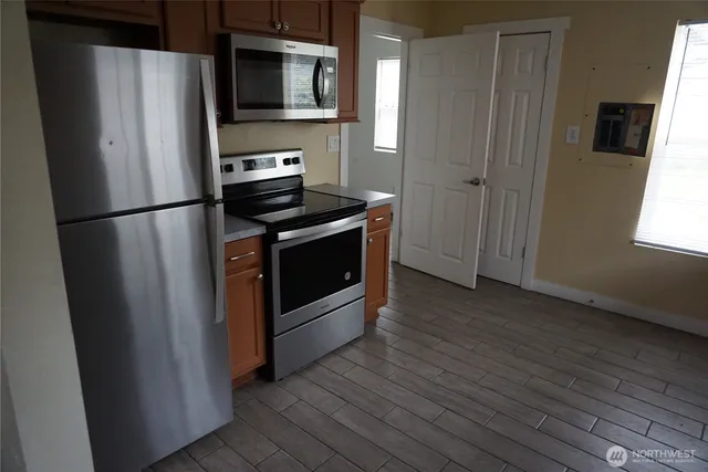 a metallic refrigerator freezer sitting in a kitchen