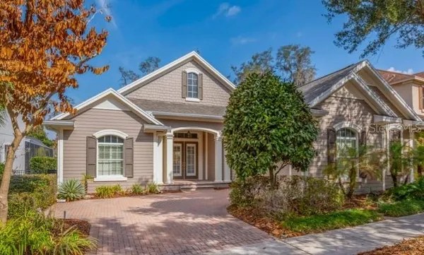 a view of a house with a yard and potted plants