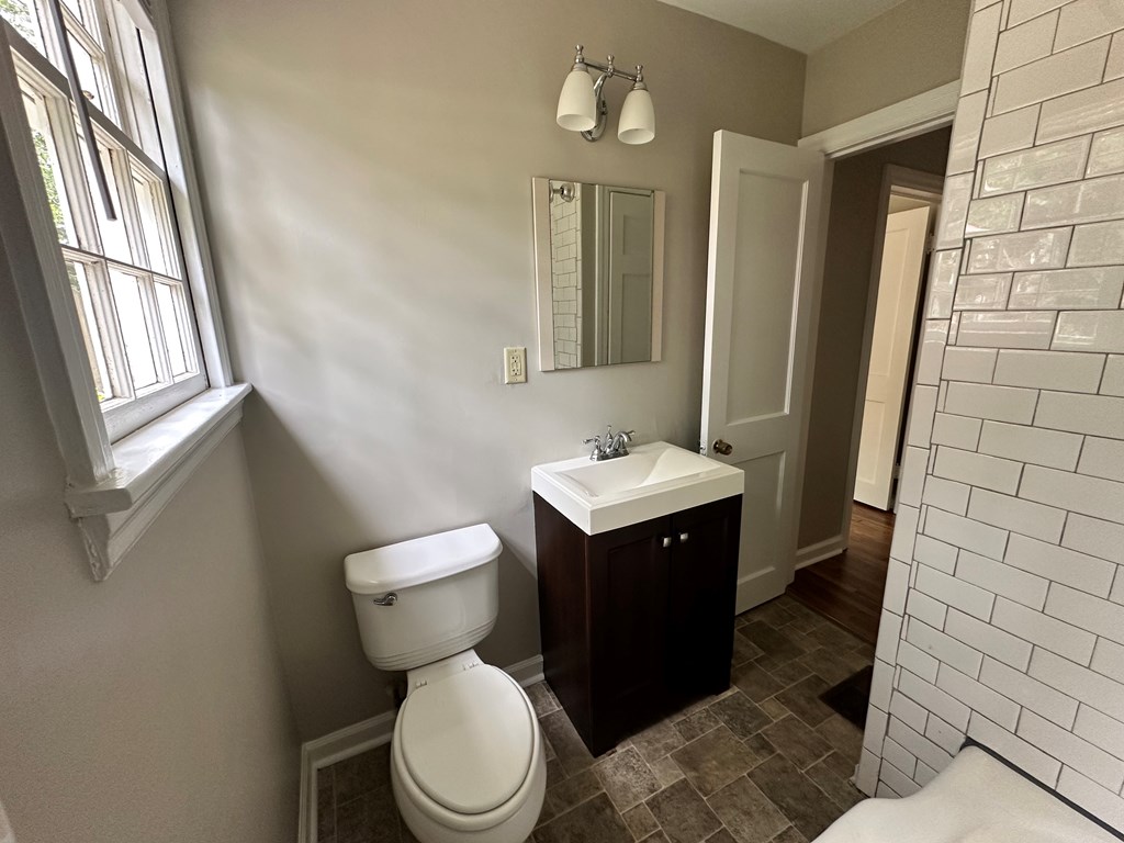 3136 Norris Road Columbus, GA 31907 - Photo 11 of 17 a bathroom with a toilet sink and mirror