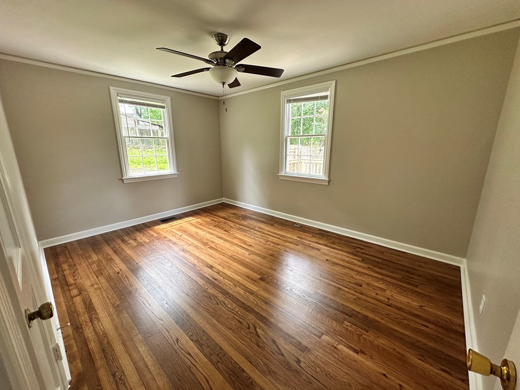 3136 Norris Road Columbus, GA 31907 - Photo 6 of 17 a view of empty room with wooden floor and fan