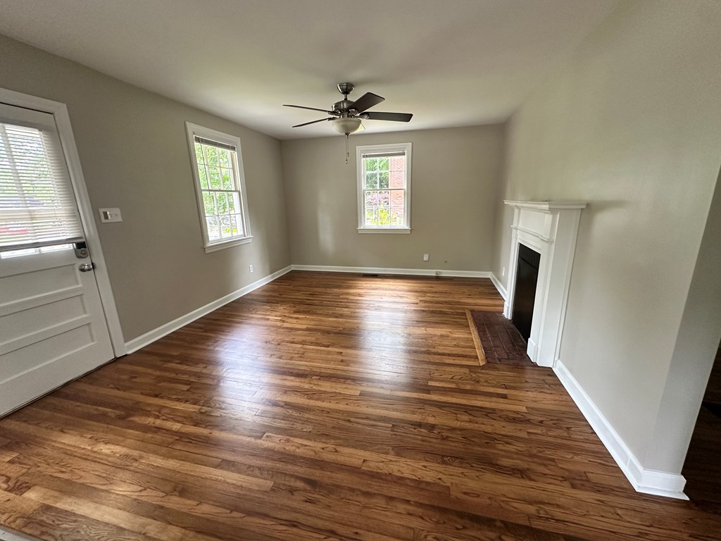 3136 Norris Road Columbus, GA 31907 - Photo 8 of 17 a view of an empty room with wooden floor and a window