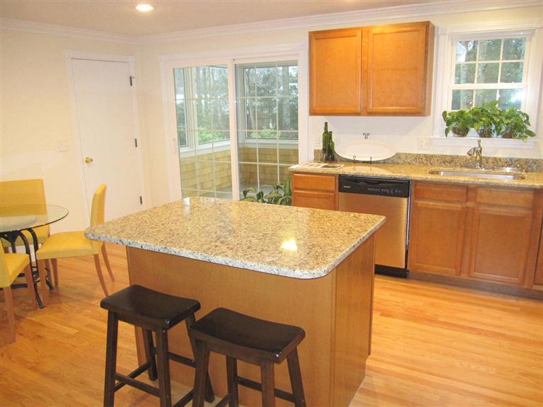 75 Beldan Lane Centerville, MA 02632 - Photo 8 of 24 a kitchen with a sink a table and chairs in it