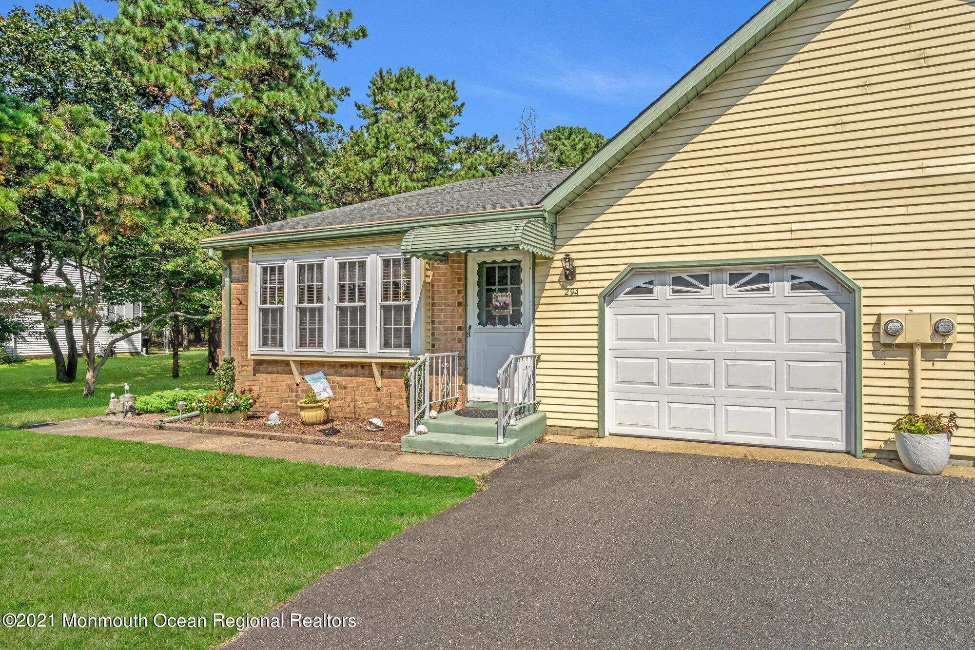 29 A Sunset Road, Unit A Whiting, NJ 08759 - Photo 7 of 40 a front view of a house with a yard and garage