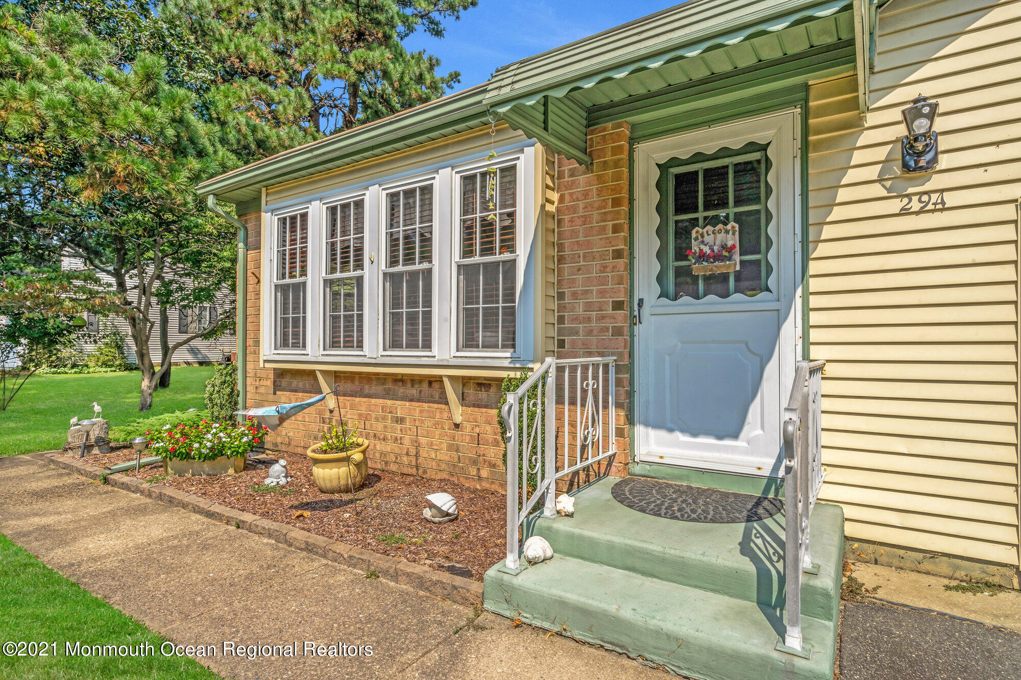 29 A Sunset Road, Unit A Whiting, NJ 08759 - Photo 8 of 40 a front view of a house with a chairs and table in a patio