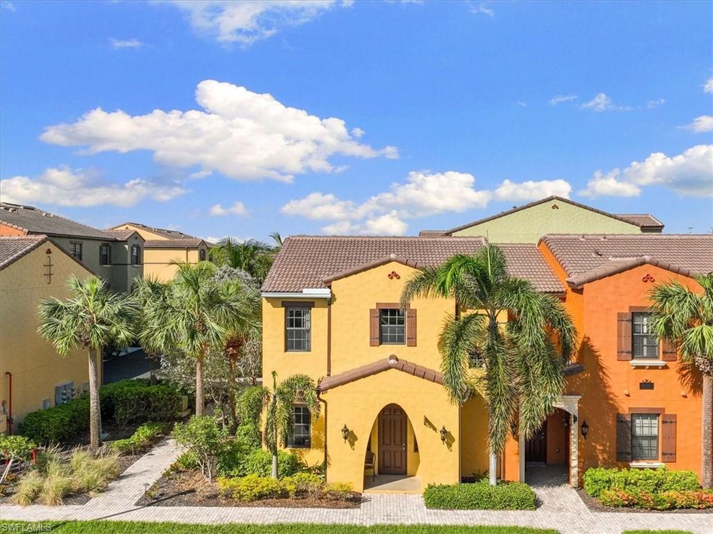8997 Cambria Circle, Unit 201 Naples, FL 34113 - Photo 20 of 33 a view of a white house with a yard