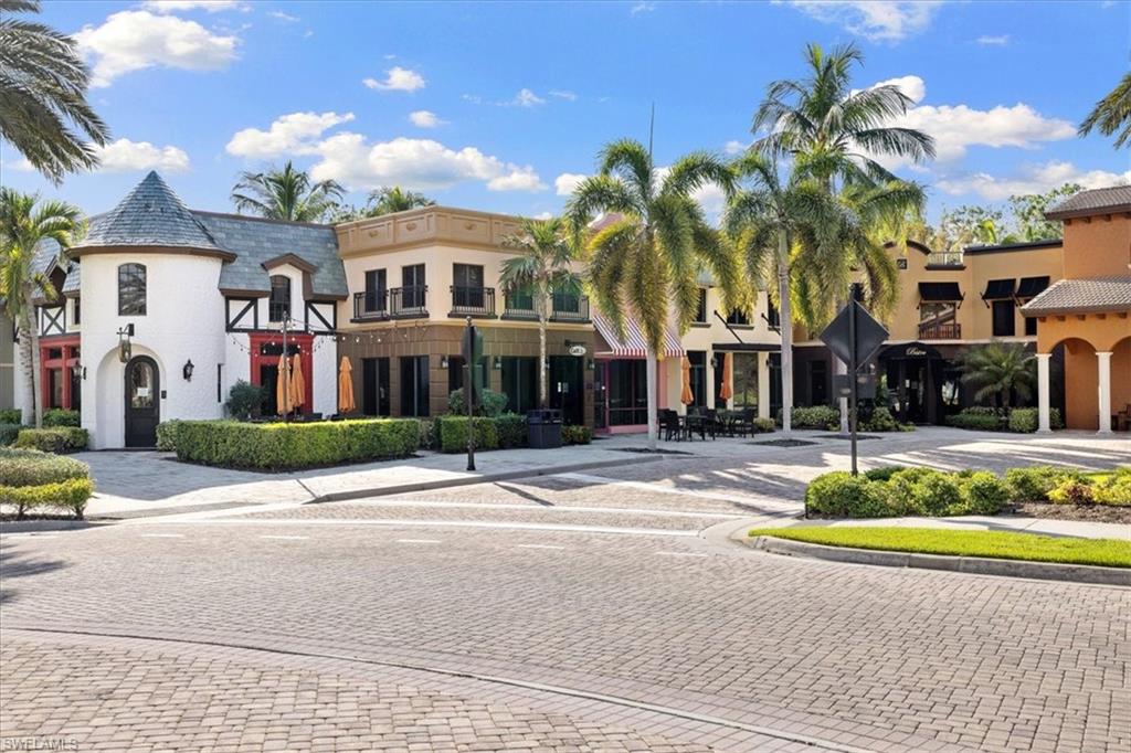 8997 Cambria Circle, Unit 201 Naples, FL 34113 - Photo 22 of 33 a front view of a house with a yard