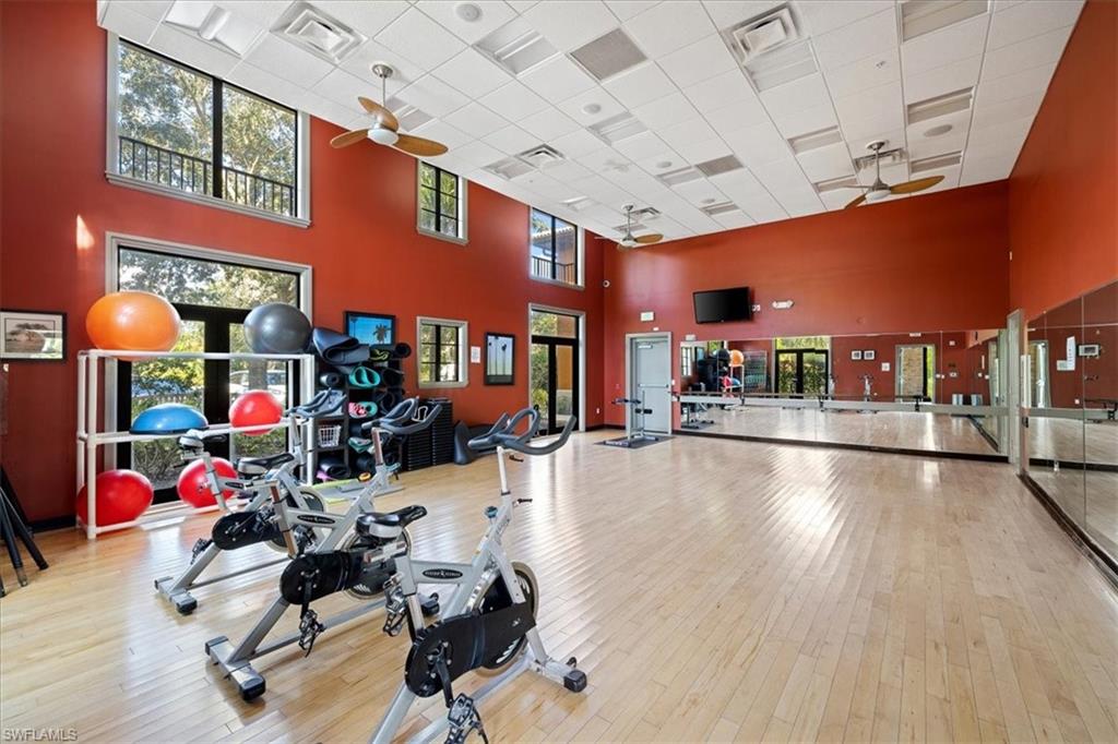 8997 Cambria Circle, Unit 201 Naples, FL 34113 - Photo 25 of 33 a gym room with lots of gym equipment