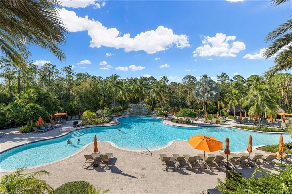 8997 Cambria Circle, Unit 201 Naples, FL 34113 - Photo 26 of 33 an aerial view of a house with swimming pool a yard and outdoor seating