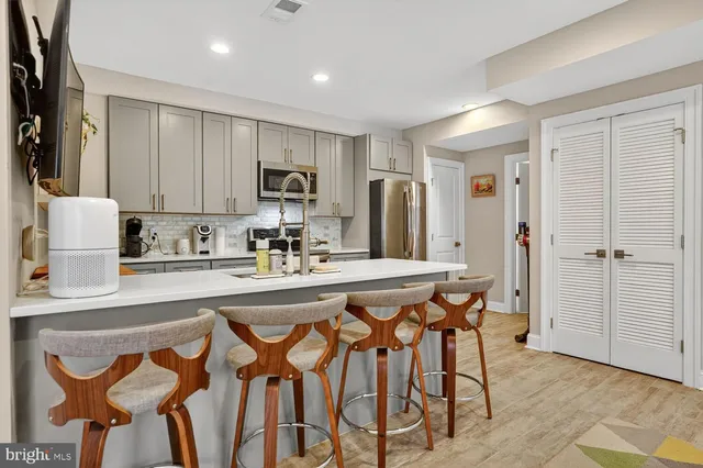 a kitchen with stainless steel appliances granite countertop a refrigerator and microwave
