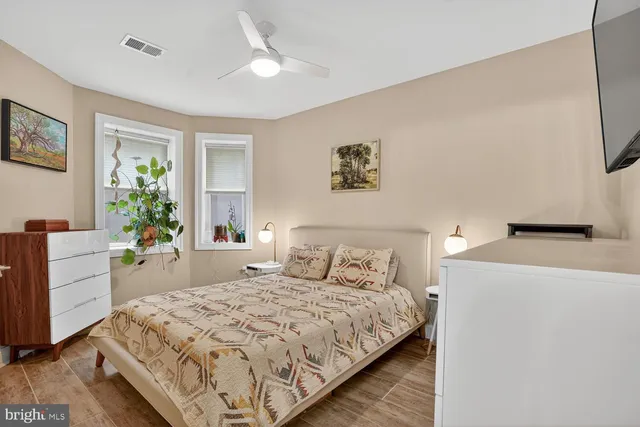 a bedroom with a large bed and a desk