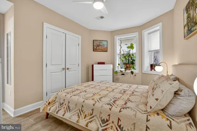 a bedroom with a bed and wooden floor
