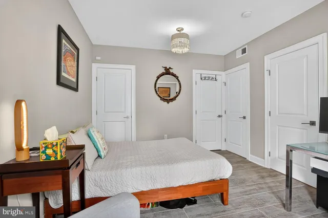 a bedroom with a bed and chandelier