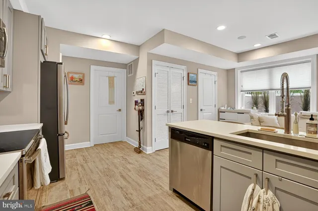 a kitchen with a sink and refrigerator