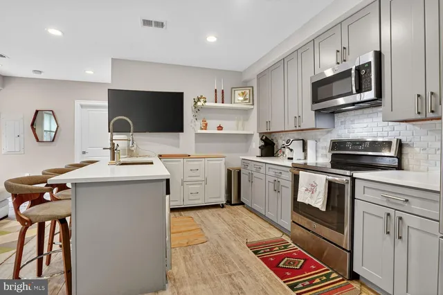 a kitchen with a sink cabinets and stainless steel appliances