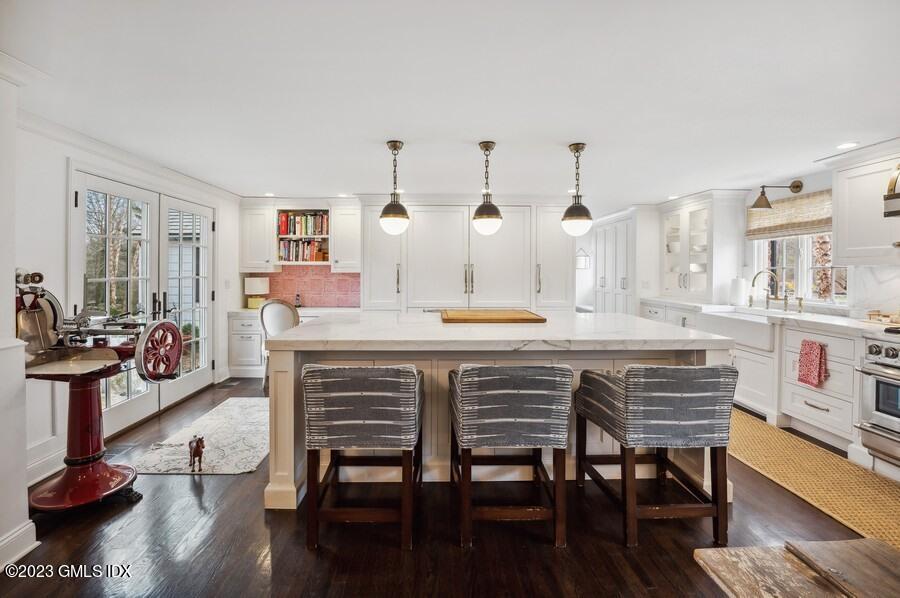 9 Cameron Drive Greenwich, CT 06831 - Photo 13 of 43 a kitchen with a table chairs refrigerator and cabinets
