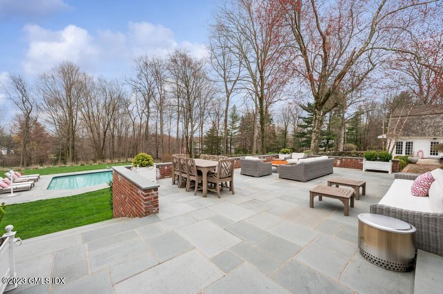9 Cameron Drive Greenwich, CT 06831 - Photo 25 of 43 a view of a patio with couches and a fire pit