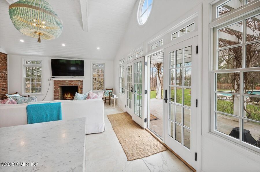 9 Cameron Drive Greenwich, CT 06831 - Photo 29 of 43 a living room with furniture a flat screen tv and a fireplace