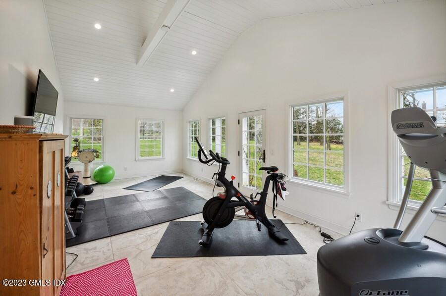 9 Cameron Drive Greenwich, CT 06831 - Photo 33 of 43 a living room with furniture a window and gym equipment