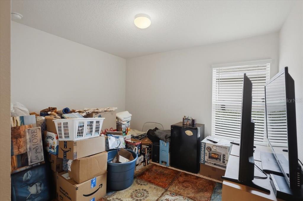 35 Birdie Way Bunnell, FL 32110 - Photo 16 of 57 a work room with furniture and musical instruments