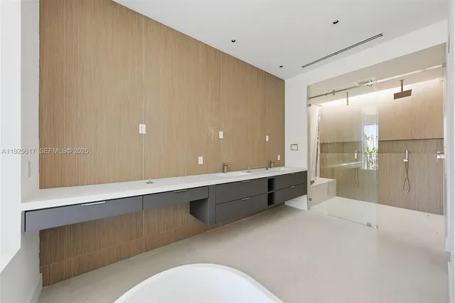 a bathroom with a bathtub shower sink and mirror