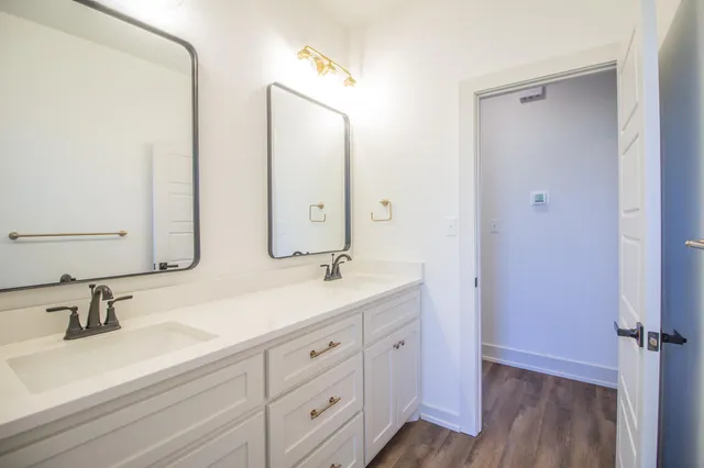 a bathroom with a double vanity sink and mirror