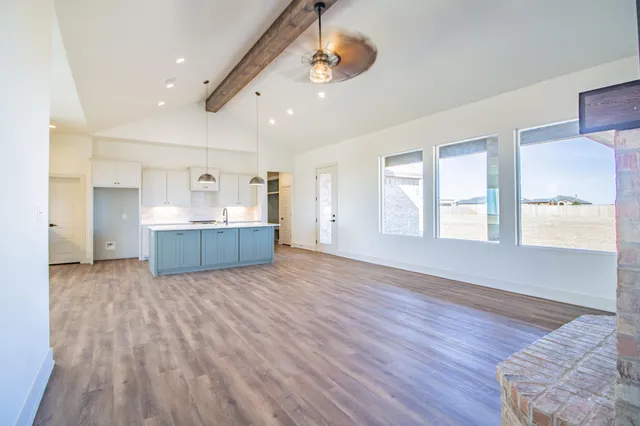 a kitchen with a sink cabinets and a wooden floor