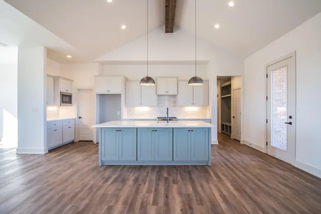 a stove top oven sitting inside of a kitchen