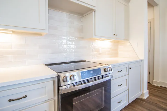 a living room with hard wood floors and a fireplace