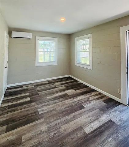 a view of a room with wooden floor and window