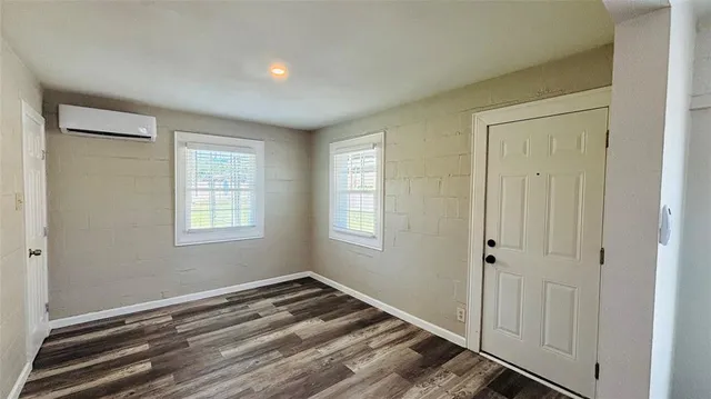 a view of a room with wooden floor and window